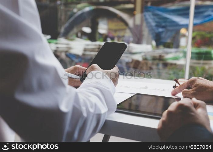 businessman working with document, smartphone and digital tablet for use as office workplace concept