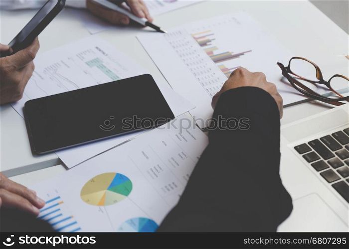 businessman working with document, smartphone and digital tablet in office workplace - blur for background