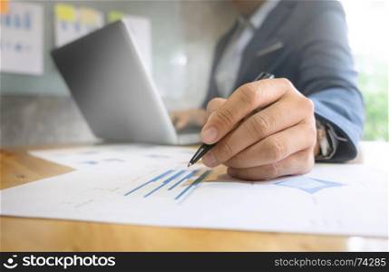 Businessman working with documents and laptop in a modern office