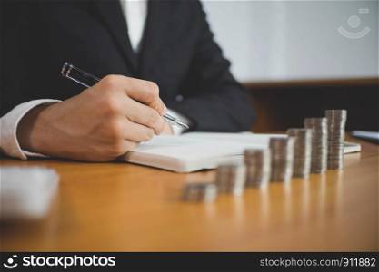 Businessman working with income statement document on the wood table.Business concept.