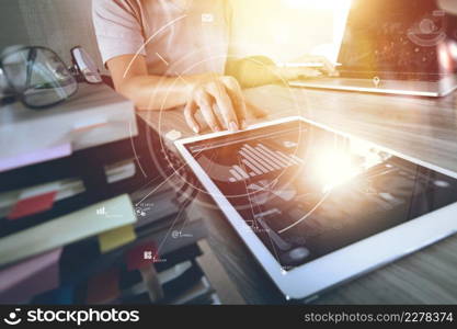 businessman working with mobile phone and digital tablet and laptop computer on wooden desk in modern office with virtual icon diagram