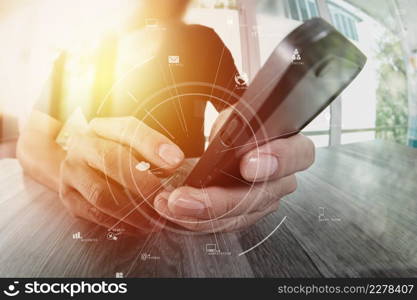 businessman working with mobile phone and digital tablet and laptop computer on wooden desk in modern office with virtual icon diagram