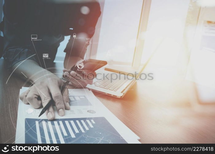 businessman working with mobile phone and digital tablet and laptop computer on wooden desk in modern office with virtual icon diagram