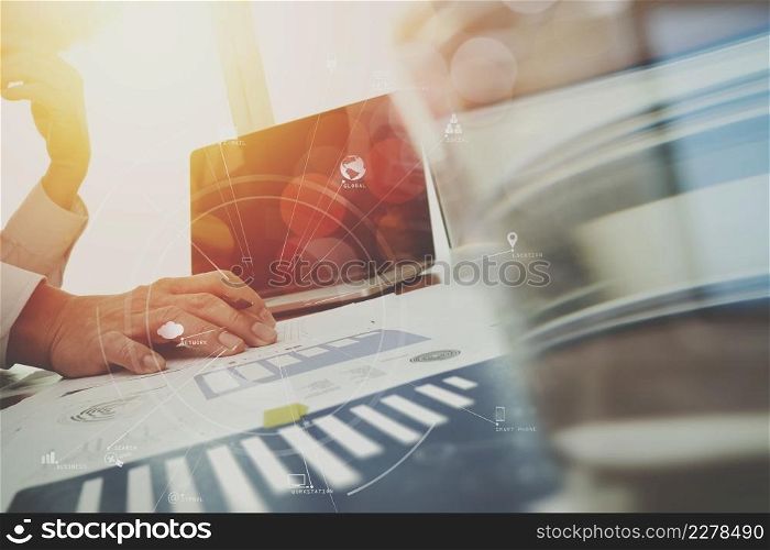 businessman working with mobile phone and digital tablet and laptop computer on wooden desk in modern office with virtual icon diagram