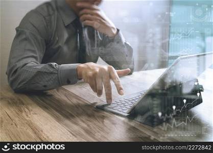 businessman working with new start up project.using smart phone digital tablet docking smart keyboard and laptop computer on wooden desk,sun effect