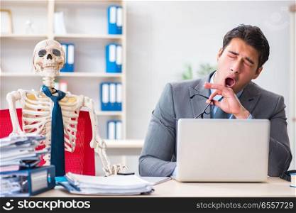 Businessman working with skeleton in office