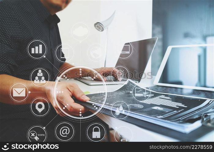 businessman working with smart phone and digital tablet and laptop computer and document in modern office with vitual icon chart and graph