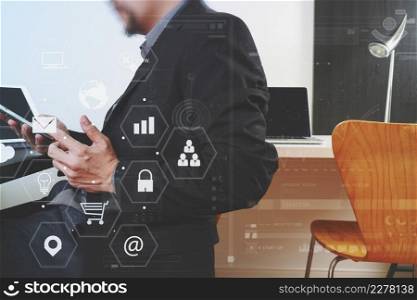 businessman working with smart phone and digital tablet and laptop computer in modern office with virtual icon diagram