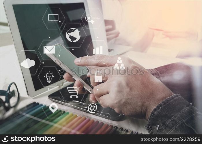 businessman working with smart phone and laptop computer on wooden desk in modern office with virtual icons interface