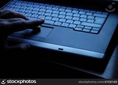 Businessman works on a laptop, close-up shot