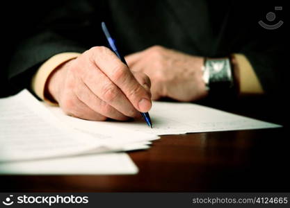 businessman works with papers,special film-like f/x,focus point on nearest part of pen