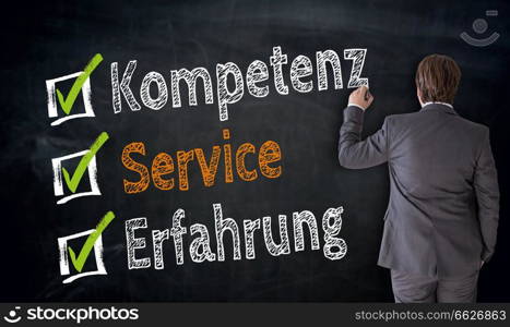 Businessman writes Kompetenz, Service, Erfahrung (in german competence, service, experience) on blackboard concept.. Businessman writes Kompetenz, Service, Erfahrung (in german competence, service, experience) on blackboard concept