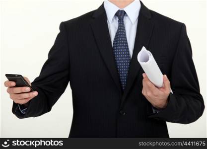 Businessman writing a message on a phone
