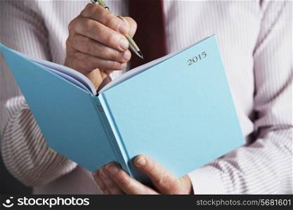 Businessman Writing In 2015 Diary