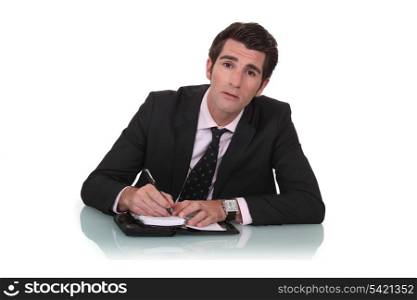 Businessman writing in his diary