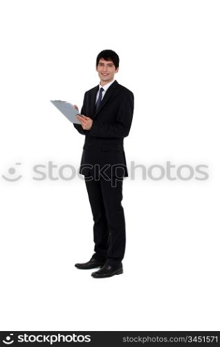 Businessman writing on a clipboard