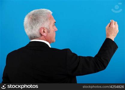 Businessman writing on an invisible board