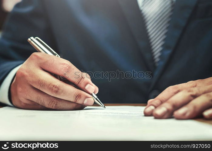 businessman writing on paper report in office concept