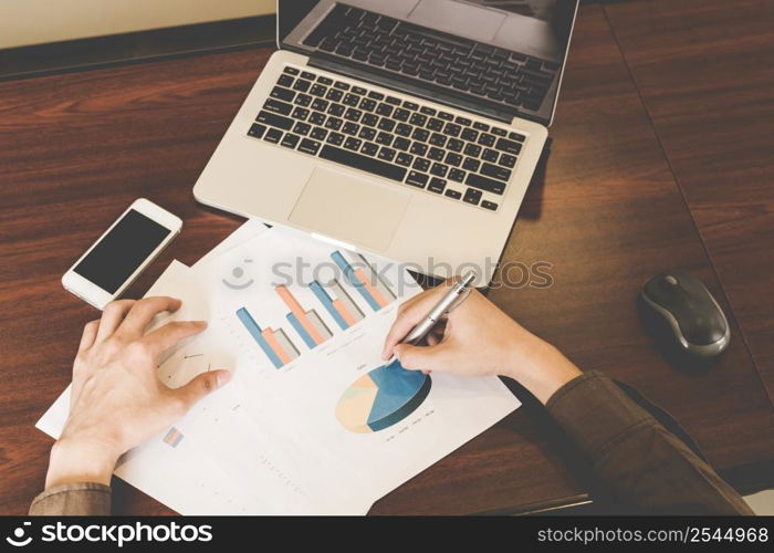 Businessman writing paper and using laptop on table. Creative Business Startup Idea.