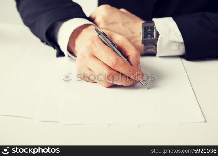 businessman writing something on the paper. picture of businessman writing something on the paper