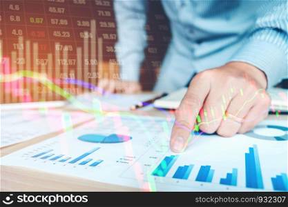 Businessman writing the trading graph of stock market