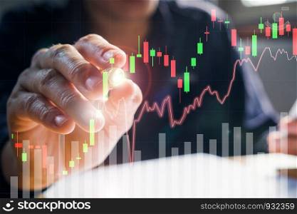 Businessman writing the trading graph of stock market on the virtual screen