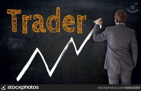 Businessman writing trader on blackboard concept.. Businessman writing trader on blackboard concept