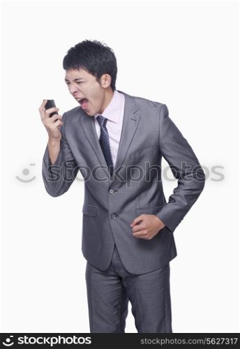 Businessman yelling at mobile phone