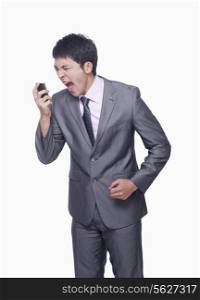 Businessman yelling at mobile phone