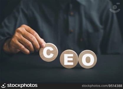 Businessmans hand picks up wooden circle with CEO text, symbolizing CEO. HR officer searches for leader and CEO. HR manager selects employee. Leader stands out from crowd. HR, HRM, HRD concepts.