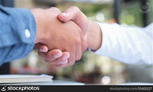Businessmans handshake. Successful businessmen handshaking after good deal. Business partnership meeting concept.