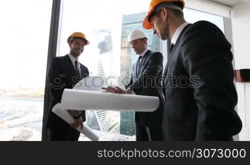 Businessmen and architects team in office planning construction project of skyscrapers