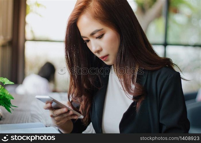 Businessmen and women are using mobile and touch smart phone for Communication and checking on business people in office background