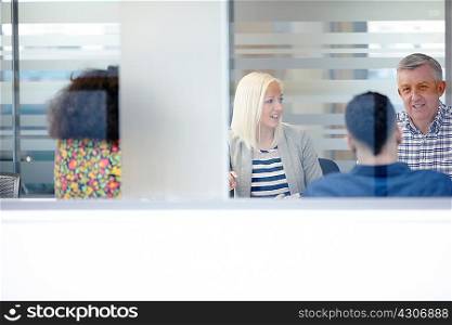 Businessmen and women having meeting at conference table