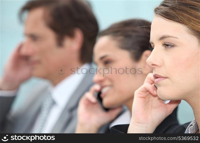 Businessmen and women on the phone.