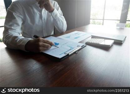 Businessmen are pointing numbers, graph, chart in business results. Business concept.