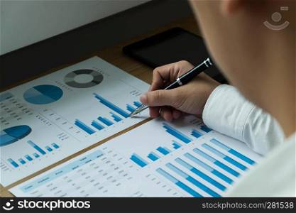 Businessmen are pointing numbers, graph, chart in business results. Business concept.