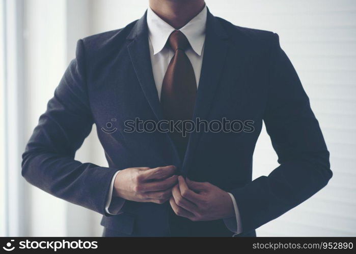 Businessmen are tying necktie. To prepare for the presentation