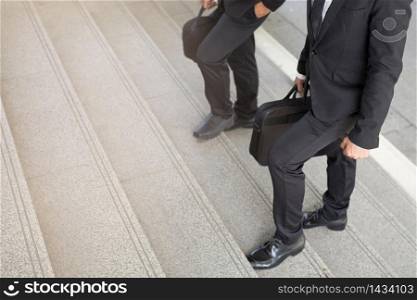 Businessmen are walking up the stairs Work at the office