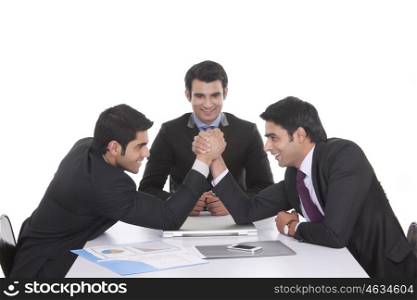 Businessmen arm wrestling
