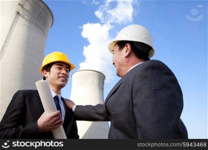 Businessmen at power plant