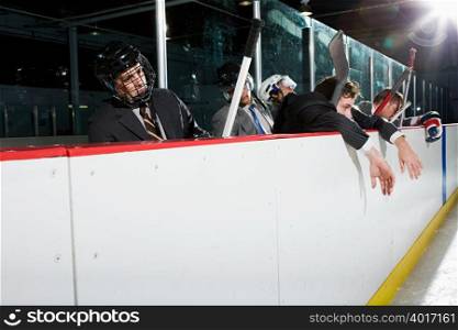 Businessmen at the edge of an ice rink