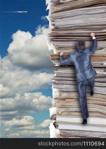 Businessmen climbing up a pile of documents