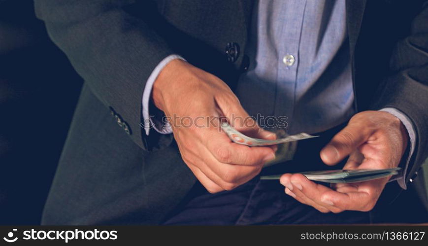 Businessmen count money and plan finances for projects and use calculators for analysis project documents and graph financial diagram working in the background on office table