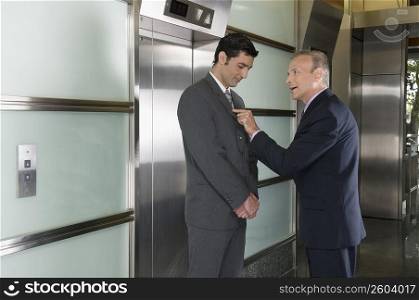 Businessmen discussing in a corridor