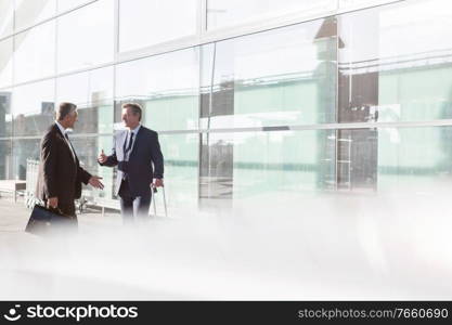 Businessmen discussing plans in the airport