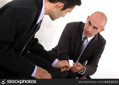 Businessmen exchanging cards