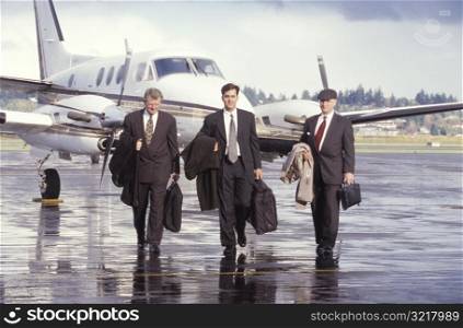 Businessmen Getting off a Plane