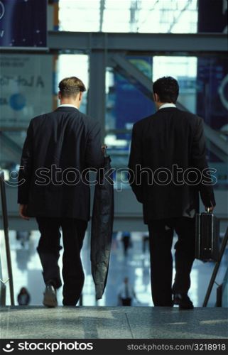 Businessmen Getting on an Escalator