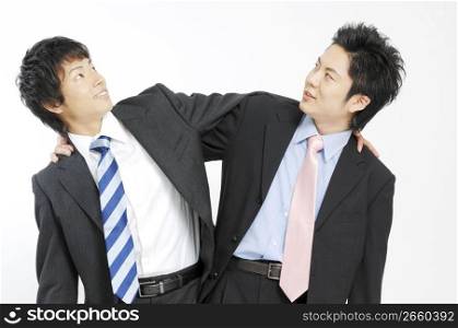 Businessmen grappling each shoulder
